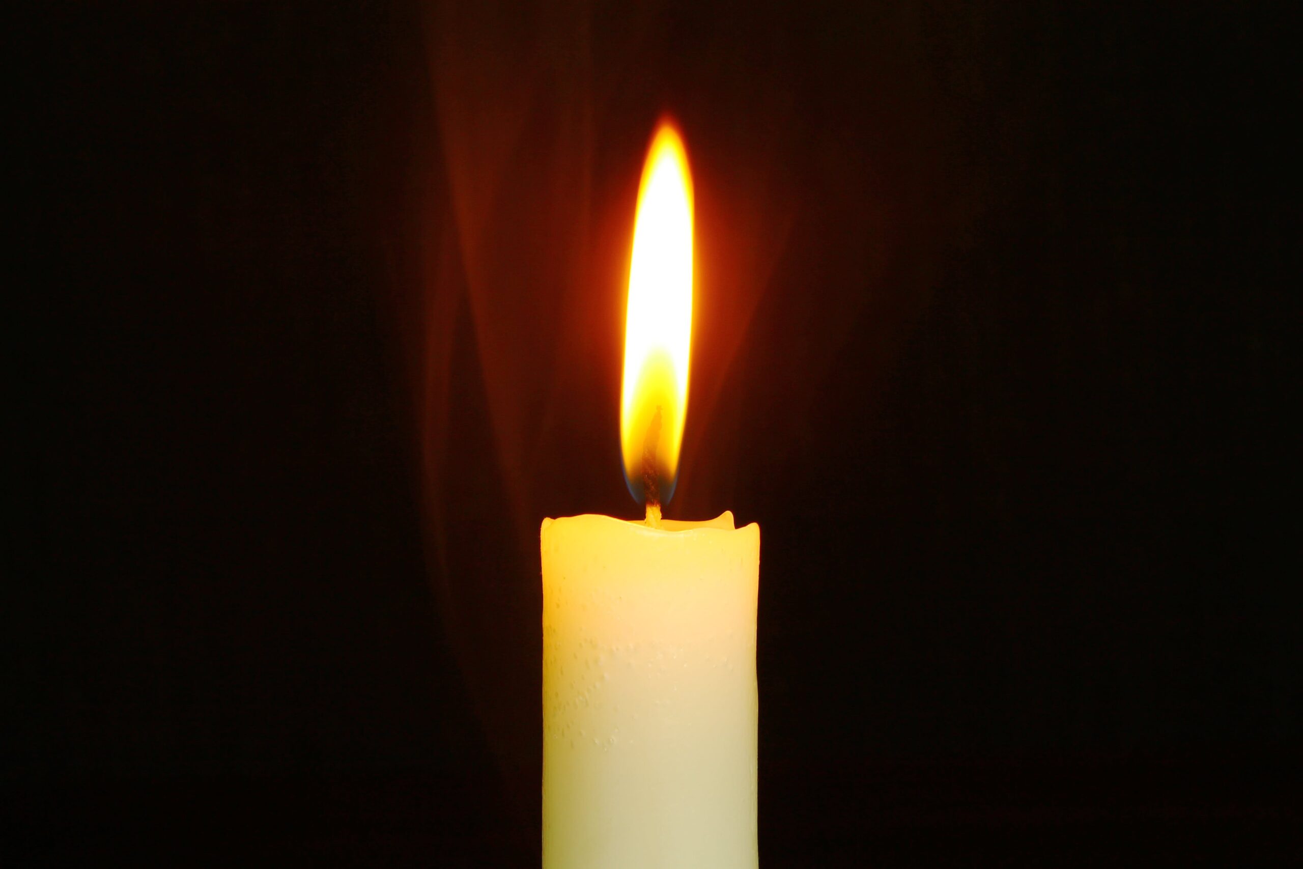 lit up candle in a dark room