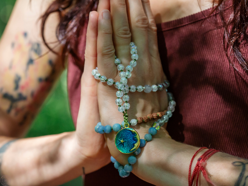 Close up of a woman’s hands in anjali mudra, symbolizing gratitude, devotion, and inner unity.